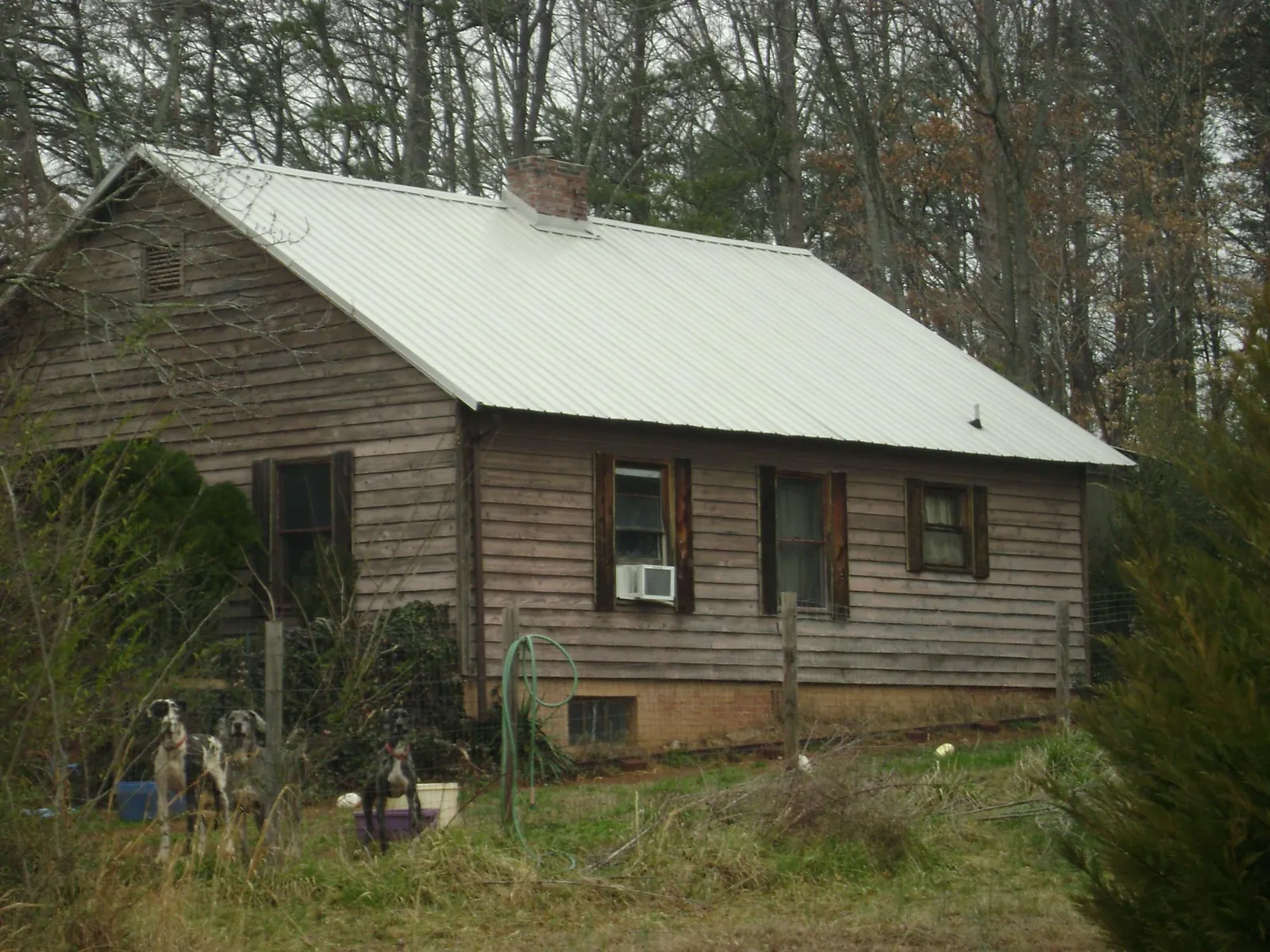 White metal roof on an old wood sided farmhouse, from a Metal Roof Installation job in Joelton